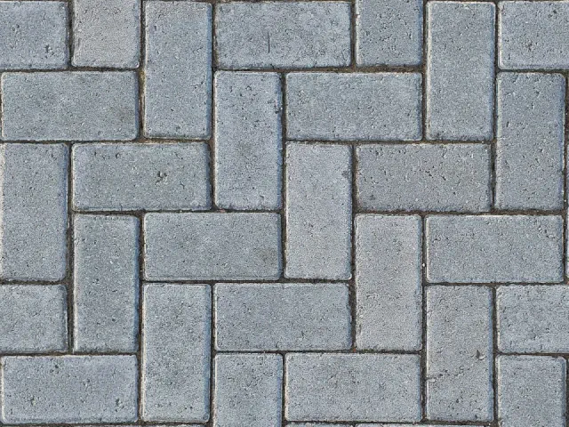 Zbliżenie szarej, prostokątnej kostki betonowej ułożonej we wzór koszykowy z par elementów