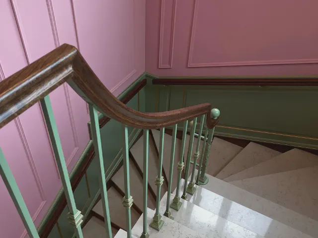 Zakręcające schody z zieloną metalową balustradą i drewnianą poręczą przy różowej ścianie z zieloną boazerią
